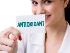 Woman holding a sign that reads Antioxidant