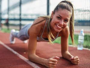 Image of a fit woman doing planks